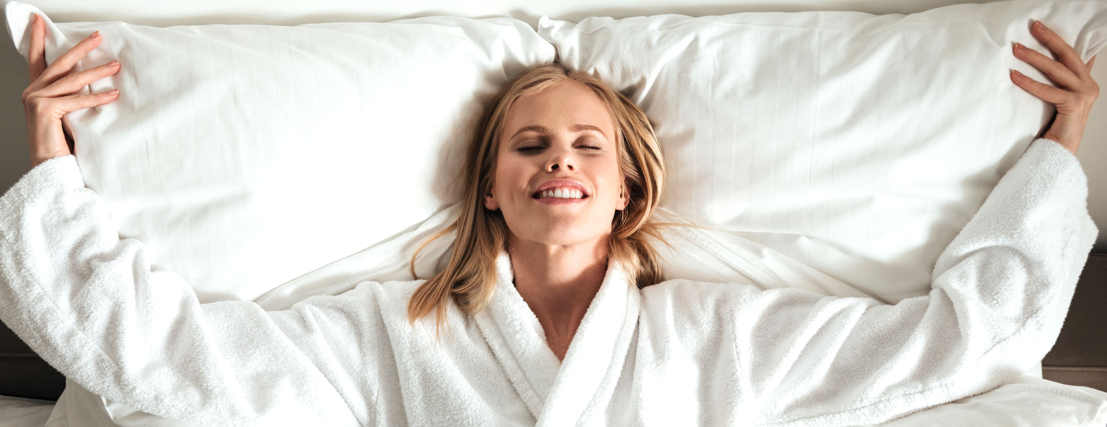 A woman lay down wrapped in a plush bathrobe