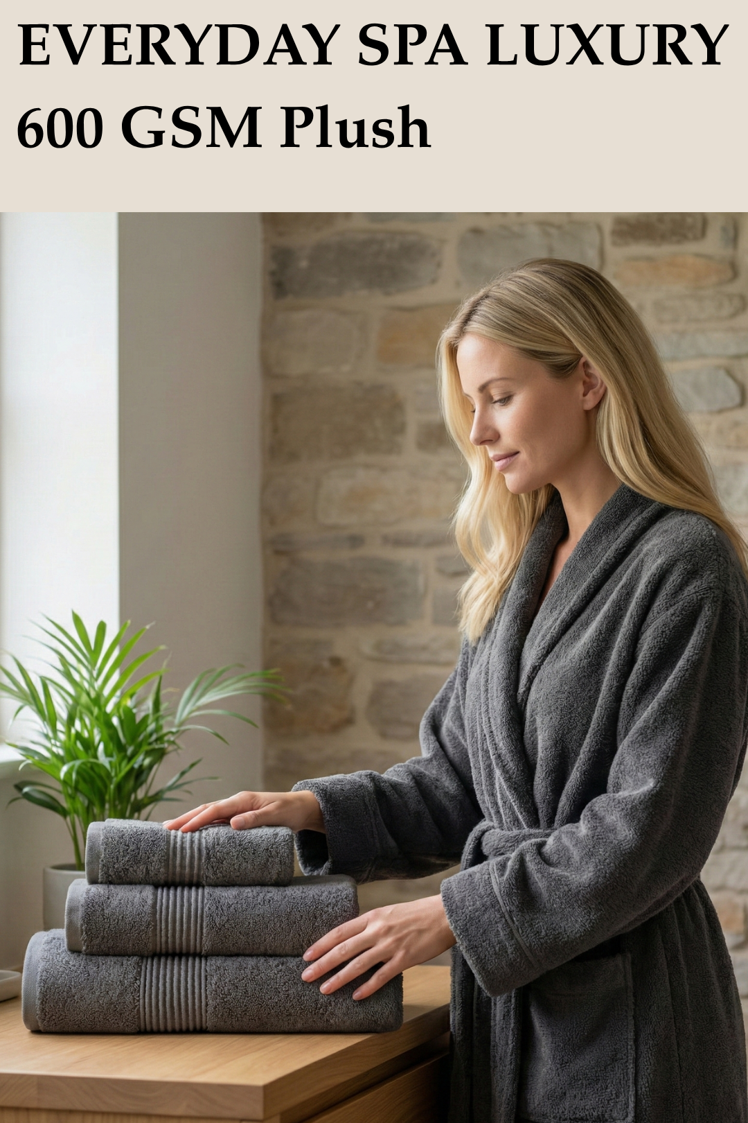 Modern bathroom scene featuring a woman with a three-piece stack of dark grey 600 GSM plush Turkish cotton towels