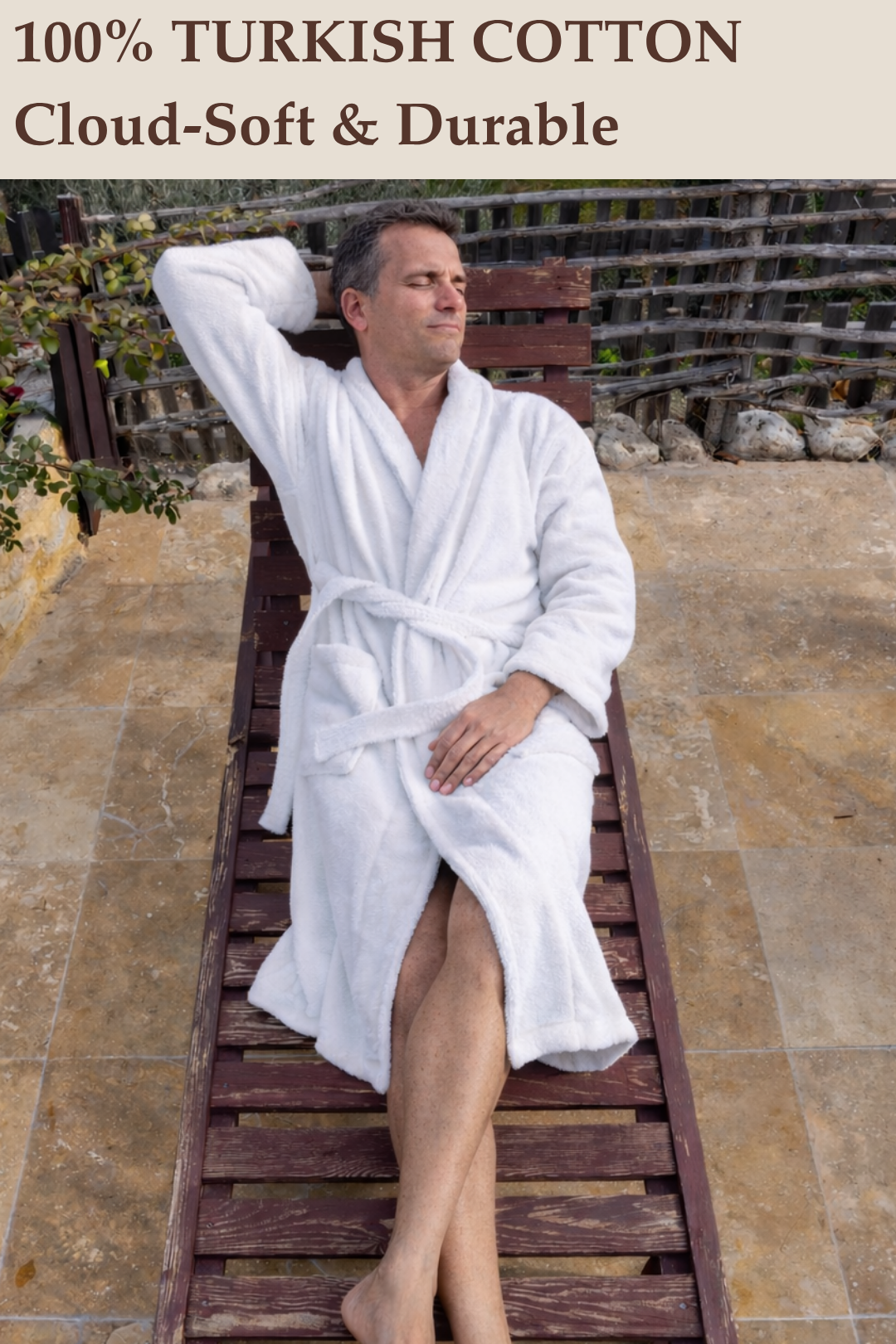A man relaxing outdoors on a wooden lounger wearing a cloud-soft, luxury Harbour Loom white 100% Turkish cotton mens bathrobe
