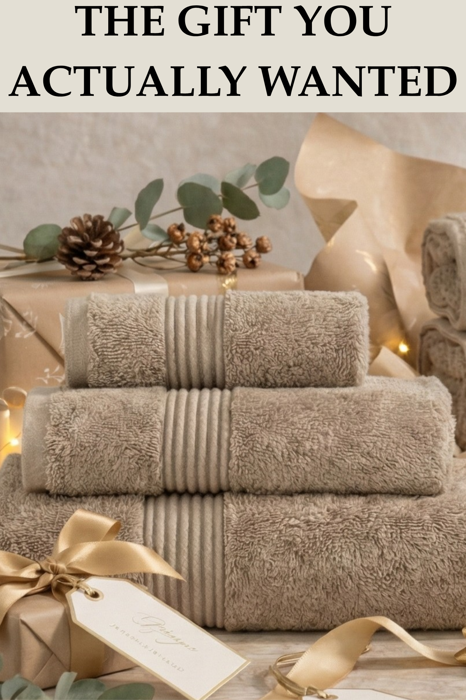 Stack of beige towels with a decorative bow and gift tag on a neutral background.