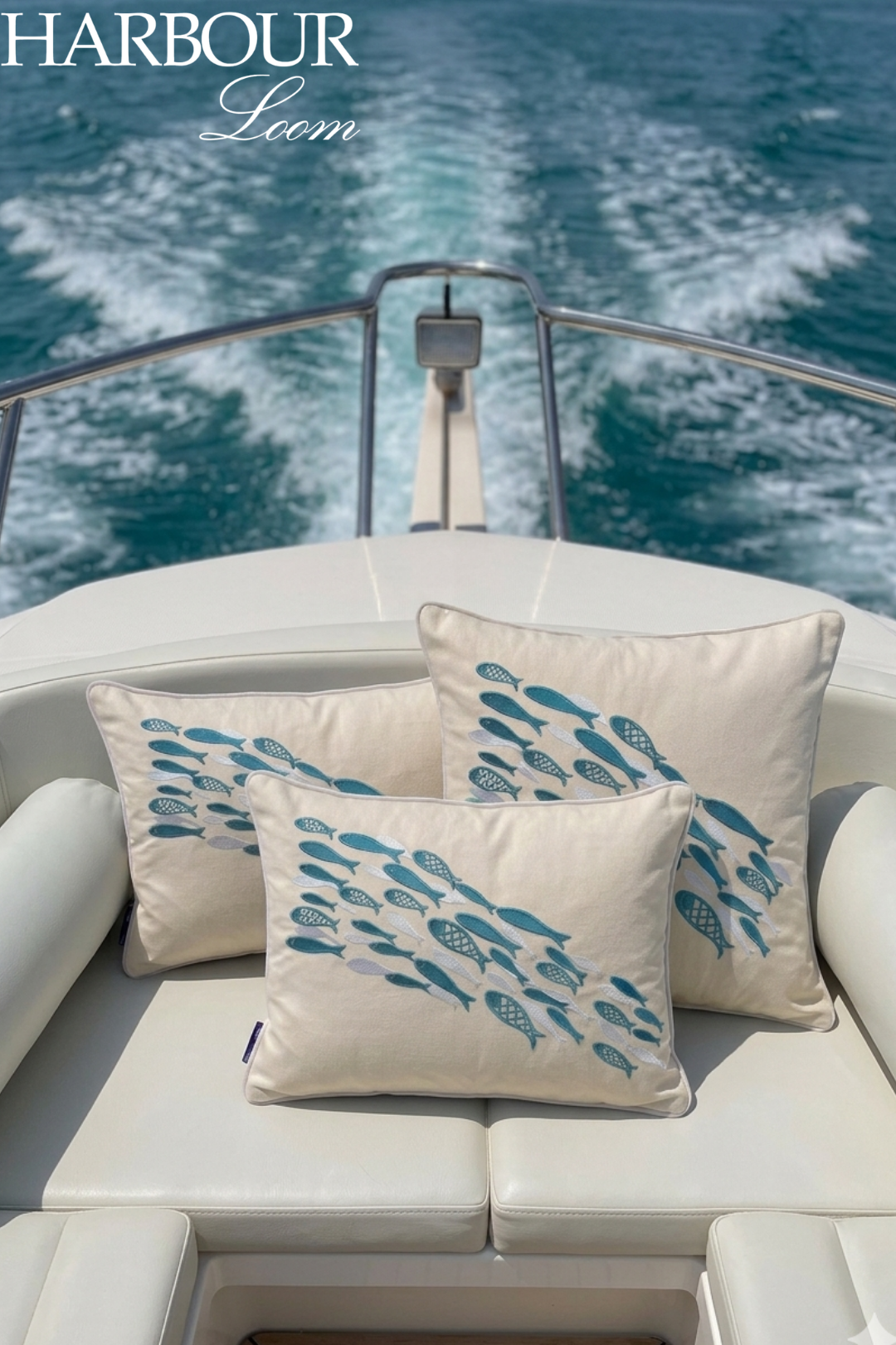 Decorative pillows with fish pattern on a boat with 'Harbour Loom' branding.
