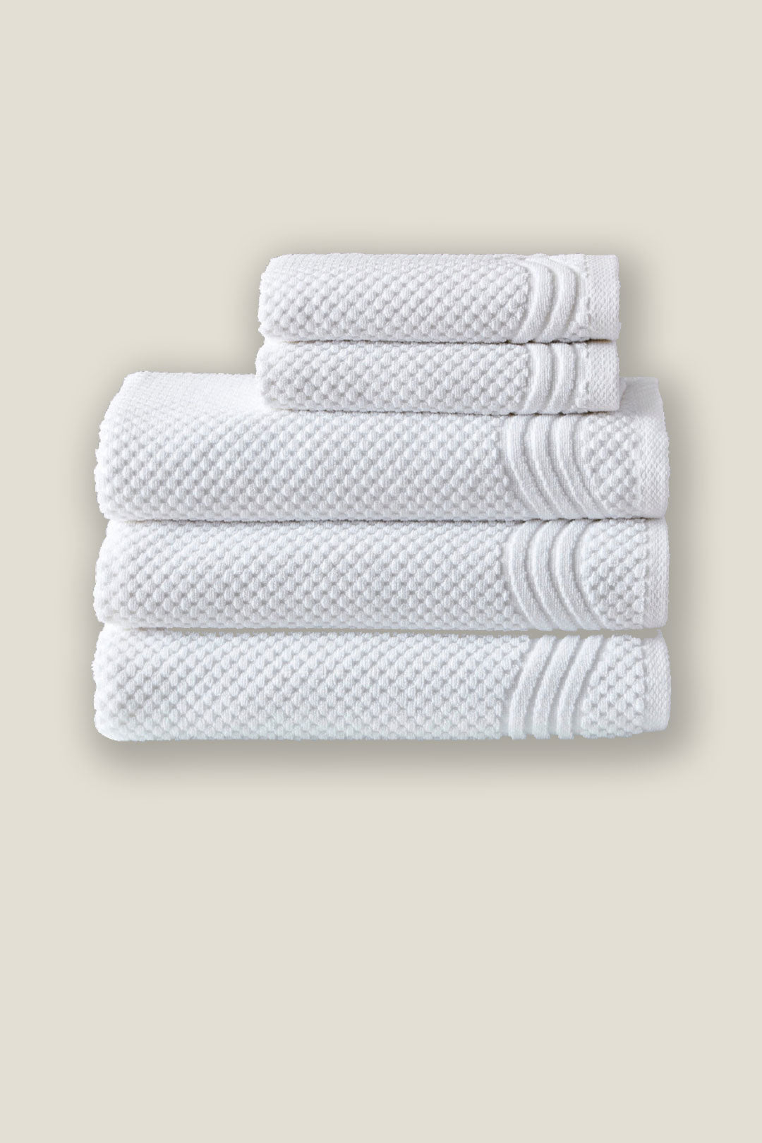 Premium white hotel towels stacked neatly, featuring soft, durable, and highly absorbent cotton ideal for luxury hospitality and spa use