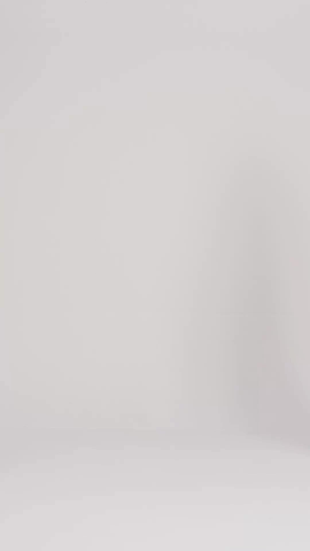 Video showcasing a man and woman modeling the plush fit and premium terry cloth texture of Harbour Loom dark grey unisex bathrobes against a clean white background