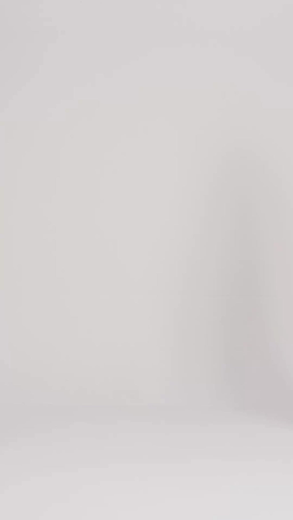 Video showcasing a man and woman modeling the plush fit and premium terry cloth texture of Harbour Loom dark grey unisex bathrobes against a clean white background